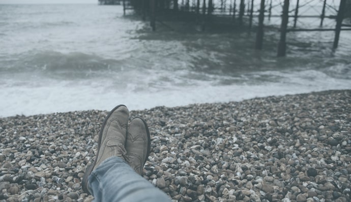 Man feet on river's bank